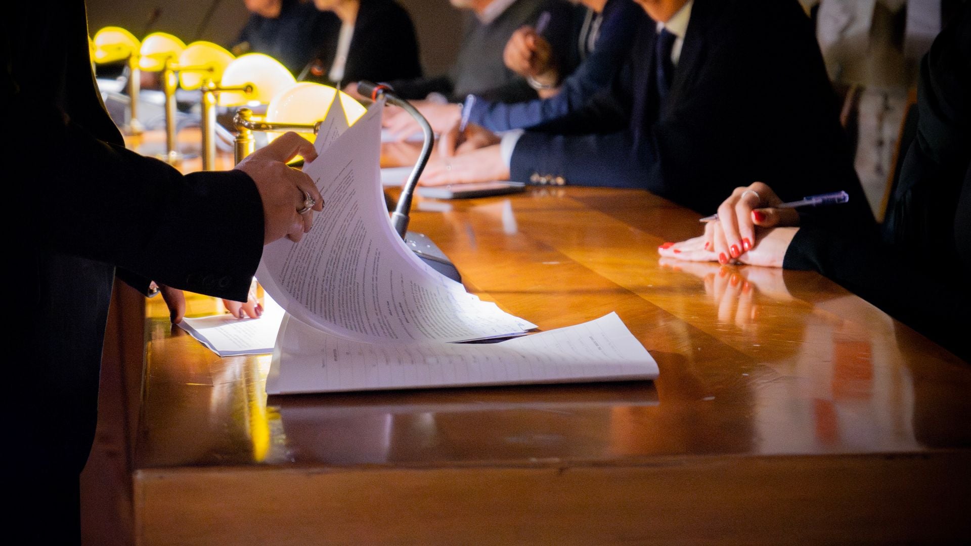 People reviewing paperwork around a meeting table