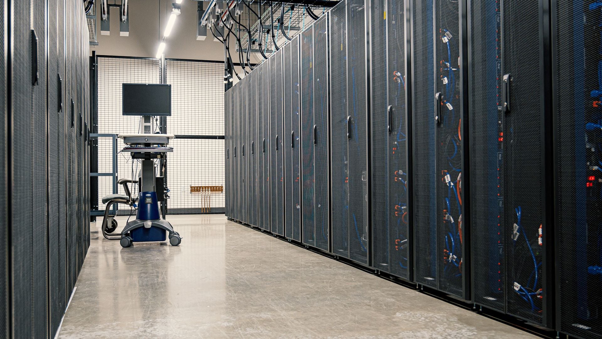 Server racks line a data-center corridor.