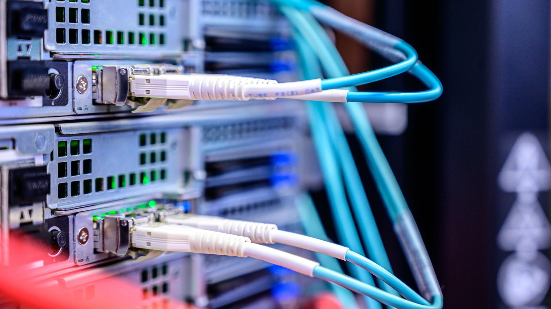 Blue network cables connect to the rear of server equipment.