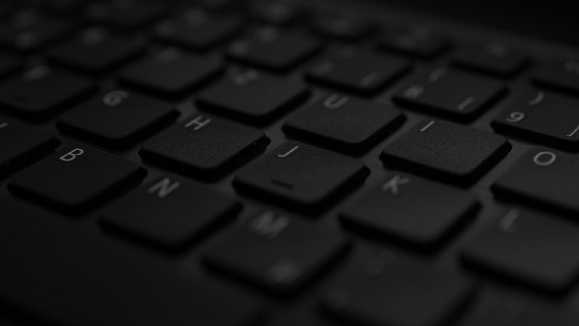 Close-up of the keys on a black laptop keyboard.