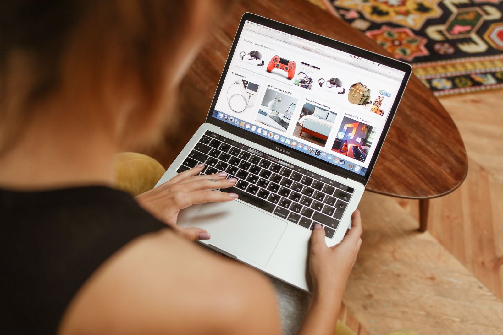 Person browsing products on a laptop at home