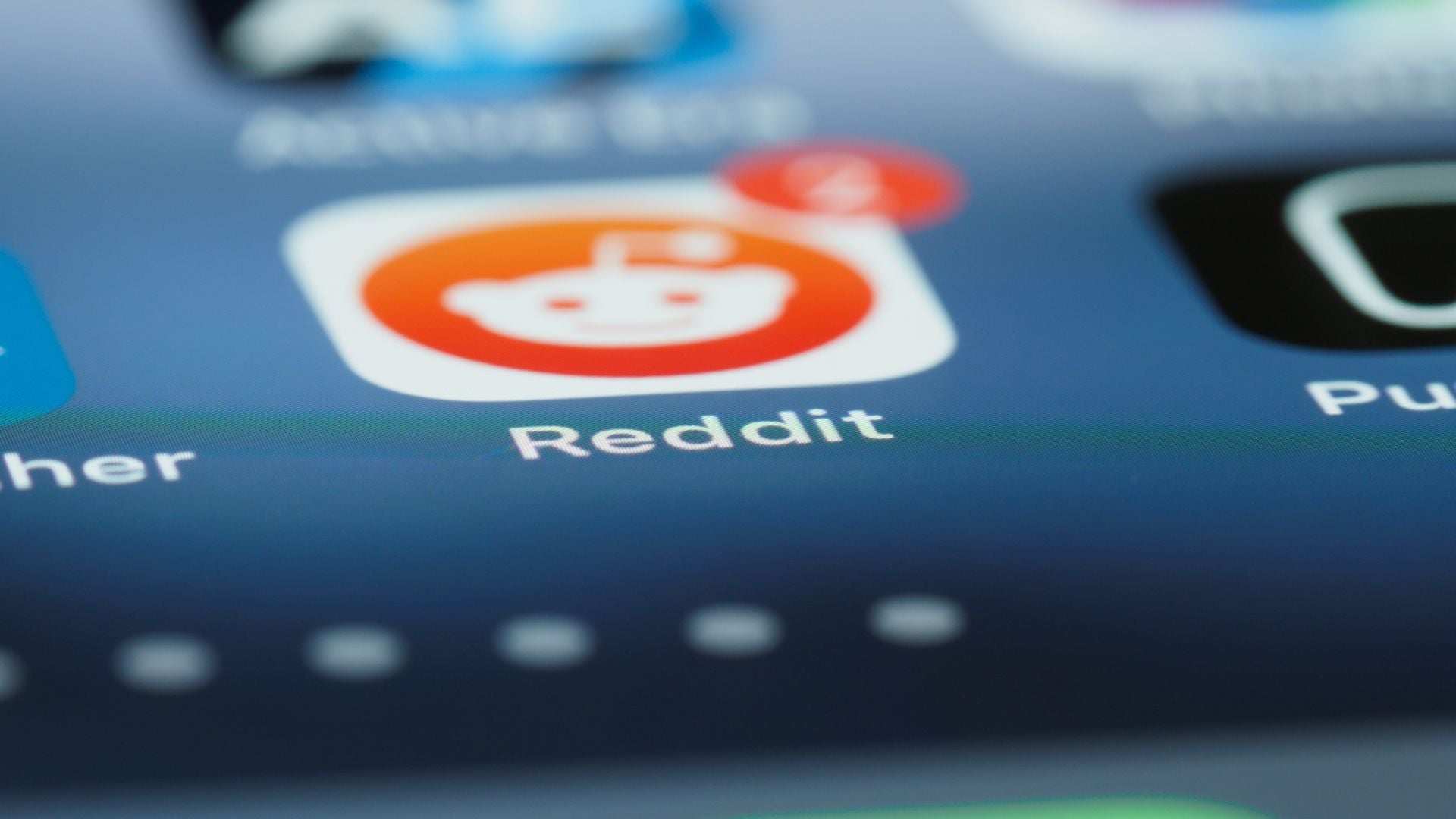 Close-up of the Reddit app icon on a smartphone screen