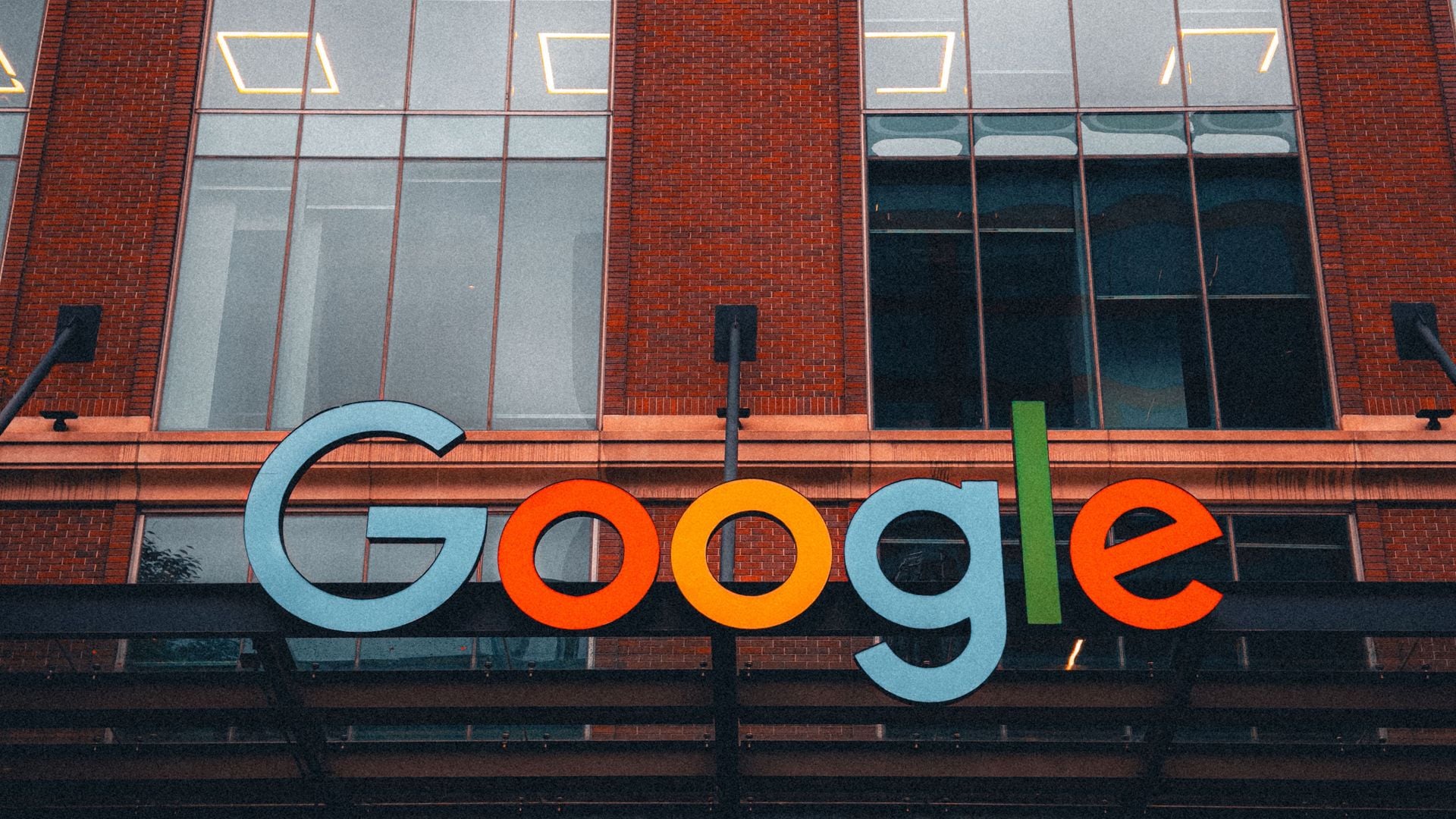 Colorful Google sign mounted on a brick and glass building