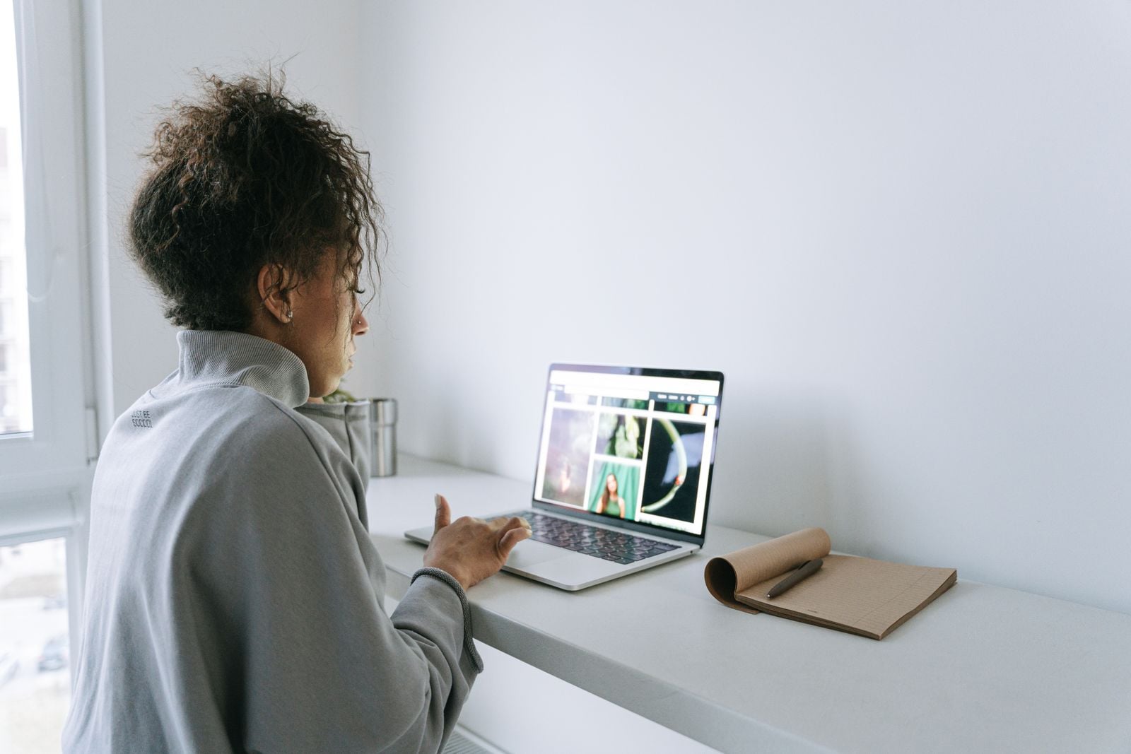 Woman browsing a website on a laptop at a desk