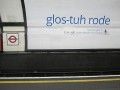 A photograph of an advert for Google Voice on the London Underground, at the station Gloucester Road. The poster spells out the stop name as it's pronounced, "glos-tuh rode", and underneath reads, "Say it to get it. Google voice search for mobile".
